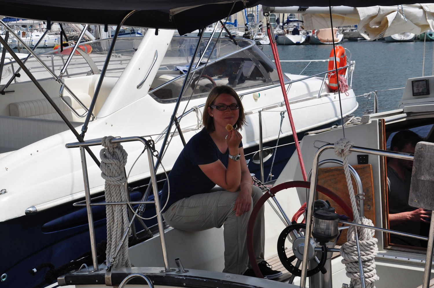 Motorboot-u. Segelschule Ravensburg - Wassersportausbildung und lizenzierung - Eine Frau sitzt auf dem Deck eines Segelboots.